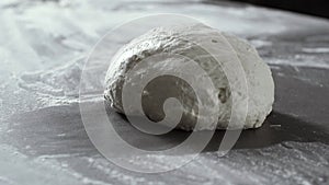 Fresh pizza or bread dough on the kitchen worktop