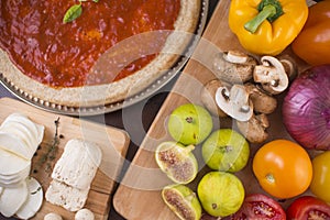 Fresh pizza ingredients on wood