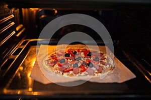 Fresh pizza on a metal baking tray