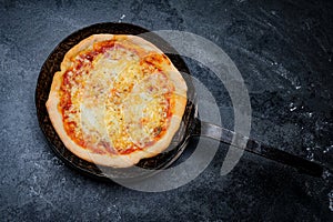 Fresh Pizza in an rustic iron Pan