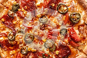 Fresh pizza with tomato sauce, black olives, mozzarella cheese, ham on wooden table closeup. Space for text or copy space. Pizza