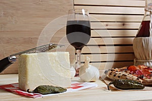 Fresh Pizza on Wooden Table at Restaurant With Bottle of Chianti Wine in Background