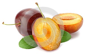 fresh plum fruit with green leaf and cut plum slices isolated on white background
