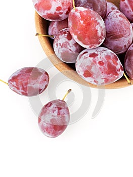 Fresh plums in a wooden bowl