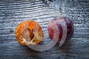 Fresh plums on a wooden table