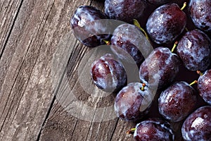 Fresh plums on wooden table