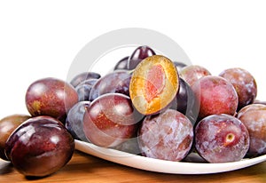 Fresh plums on wooden table