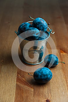 Fresh Plums on a wooden table. Useful, tasty food.