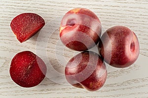 Fresh pluot interspecific plums on grey wood