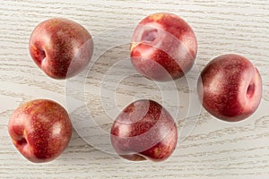 Fresh pluot interspecific plums on grey wood