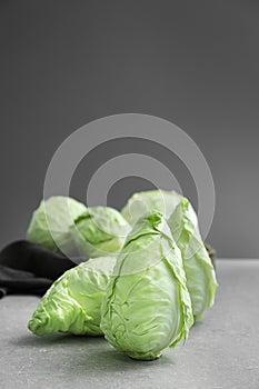 Fresh pointed cabbage on grey table