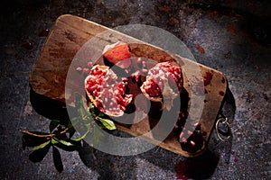Fresh pomegranate on cutting board
