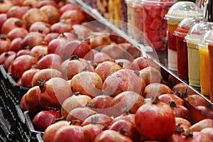 fresh pomegranate fruits displayed in a juice shop to make healthy drinks