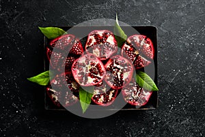 Fresh pomegranate fruits on a metal tray.