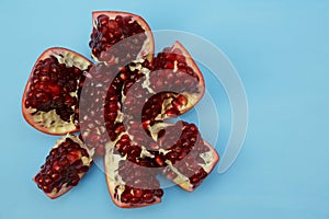 Fresh pomegranate with red seeds isolated on background. Healthy fruits, vegan food, diet. With copy space. Flat lay.