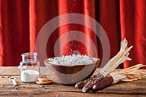 Fresh Popped Popcorn In Wood Bowl With Kernels And Corncobs On W