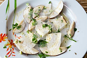 Fresh porcini mushrooms in salad with oil and parsley