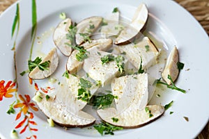 Fresh porcini mushrooms in salad with oil and parsley