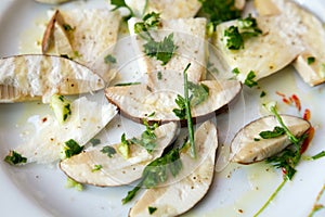 Fresh porcini mushrooms in salad with oil and parsley