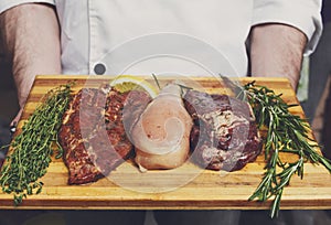 Fresh pork, beef and chicken meat on a cutting board