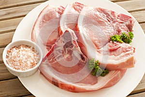 Fresh Pork Chops on Plate with Rock Salt