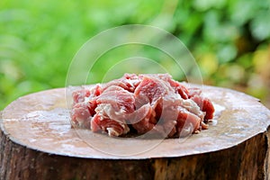 Fresh pork cut into pieces on a cutting board