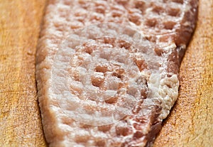 Fresh pork meat with structure on wood board