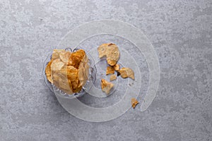 Fresh potato chips stock image with textured background.