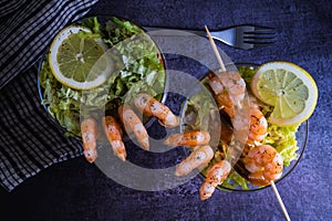 Fresh Prawn cocktail starter served in a tropical tourist restaurant in a glass with decoration of prawn with sprinkle of dill,