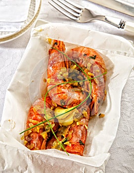 Fresh prawns cooked in papillote served in paper.