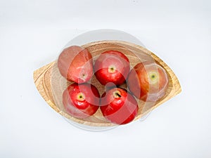 Fresh premiun quality rose apple or Syzygium samarangense with wooden bowl isolated on white background. Also known as wax apple,
