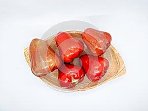 Fresh premiun quality rose apple or Syzygium samarangense with wooden bowl isolated on white background. Also known as wax apple,