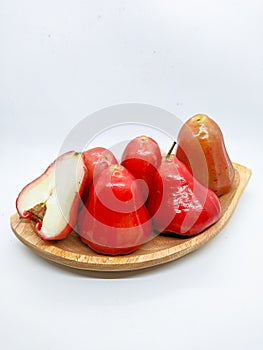 Fresh premiun quality rose apple or Syzygium samarangense with wooden bowl isolated on white background. Also known as wax apple,