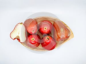 Fresh premiun quality rose apple or Syzygium samarangense with wooden bowl isolated on white background. Also known as wax apple,