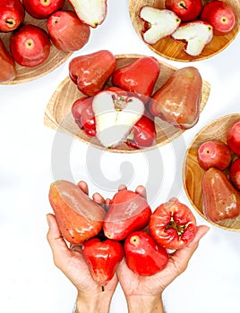 Fresh premiun quality rose apple or Syzygium samarangense with wooden bowl isolated on white background. Also known as wax apple,