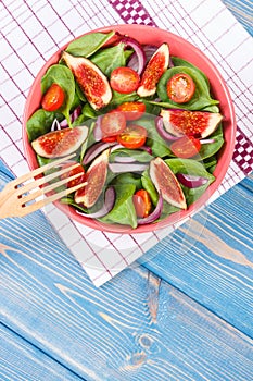 Fresh prepared fruit and vegetable salad with fork, concept of healthy lifestyle, food and nutrition