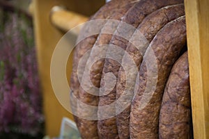 Fresh prepared smoked sausage with spices on market stall
