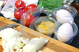 fresh products prepacked for salad. Tomatoes, sour cream, arugula.