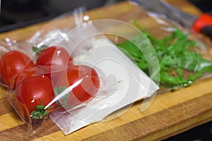 fresh products prepacked for salad. Tomatoes, sour cream, arugula.