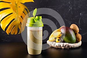 Fresh protein drink in a shaker. Protein drink with banana and fruit. Healthy food.