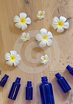 fresh pure flower essential oils exploding from protecting aromatherapy bottles