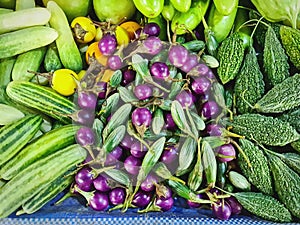 Fresh Purple Eggplants, Cucumbers and Other Fruits for Sale at Market Stall