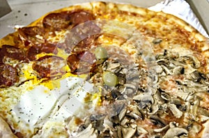 Fresh Quattro stagione pizza in a cardboard box photo