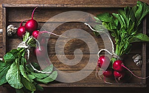 Fresh radish banches on wooden tray background, copy space