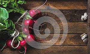 Fresh radish banches on wooden tray background, copy space