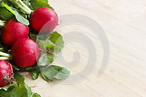 Fresh radish with greens on a wooden board