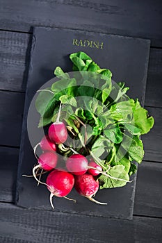 Fresh radish on stone cutting board. Copy space. Natural, organic products.