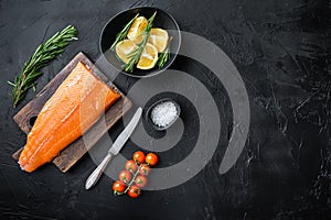 Fresh rainbow trout fillet on black background, top view with copy space