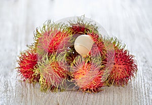 Fresh rambutans on wooden background