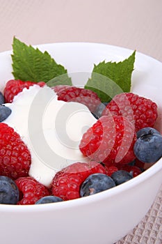 Fresh raspberries and berry with cream